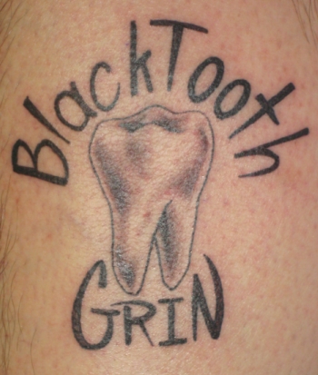 Looking for unique  Tattoos? Black tooth grin tattoo