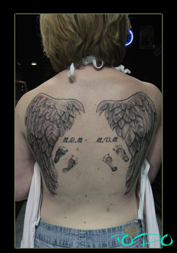 cross tattoos with wings on arm. angel wings tattoos on arm