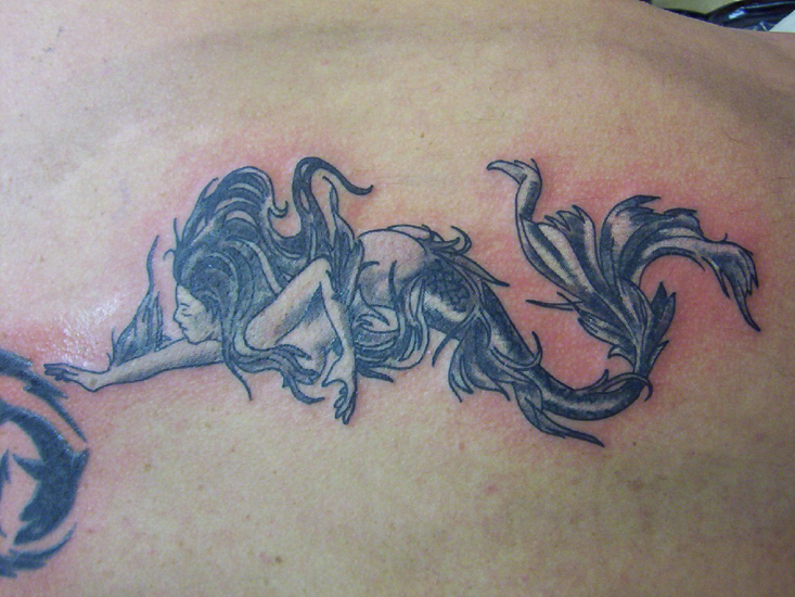 Old School-style mermaid tattoo. Anchors were also popular tattoo motifs at