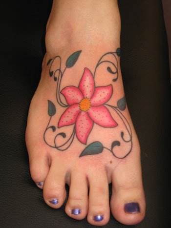 flowers tattoos on feet. hair flower tattoos on back.