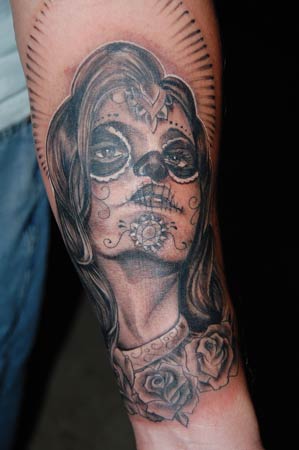 That tattoo artist needs a medal. Day Of The Dead skull ladies are becoming