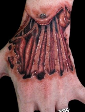 Comments: Yummy skin tear hand tattoo done on Gehenna Tattoo artist Bob