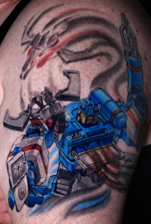 Comments: Soundwave crushing an ipod tattoo in a battle of technology.