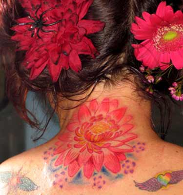 back of neck tattoos. flower tattoo on ack of neck