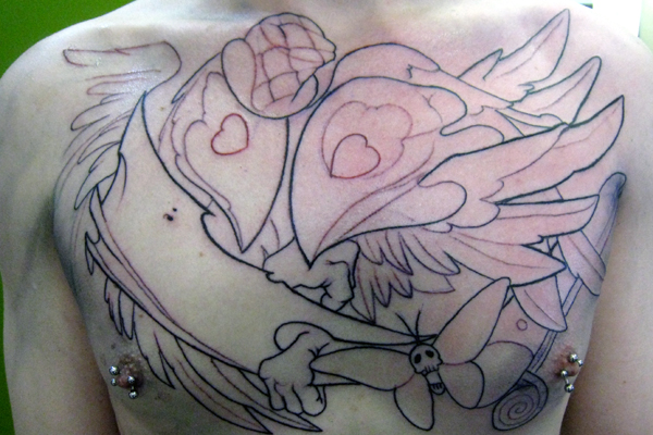 Poof tattoos in your face. This chest piece is two crows fighting over a