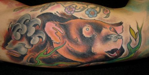 Comments: Bear tattoo on an upper inner arm.