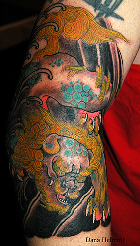 chinese lion tattoo. chinese lion and rocks and