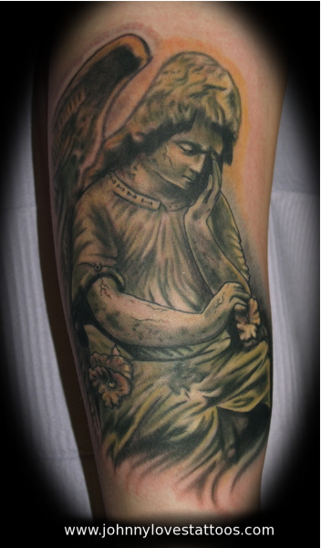 Comments: an angel statue tattoo done in black and gray with green zombie 