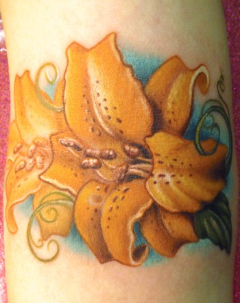 Comments: This is a tiger lily tattoo a long time in the making on my good 