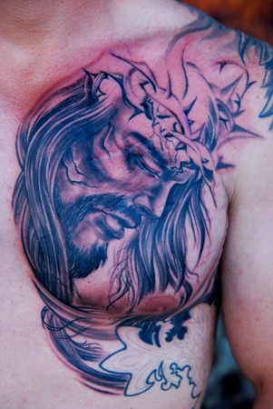 Comments: Chest plate Jesus tattoo, black and gray tattoo in progress.