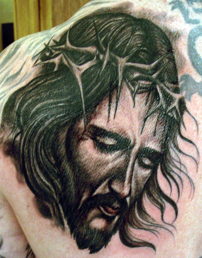 George Friel Jr. displays his tattoo of Jesus Christ on the cross.